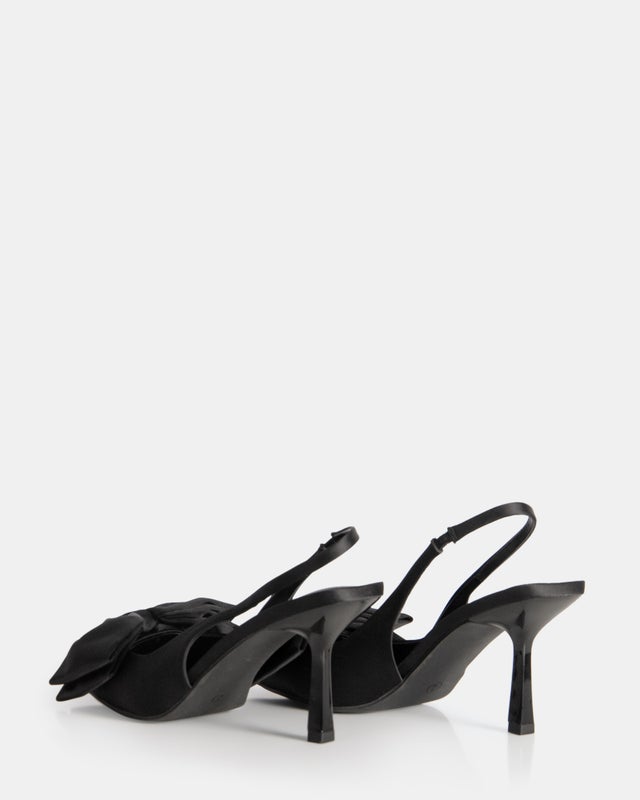 Black strappy high heel sandals with slender ankle strap and open toe design, displaying elegant black heels suitable for dressy and formal occasions.