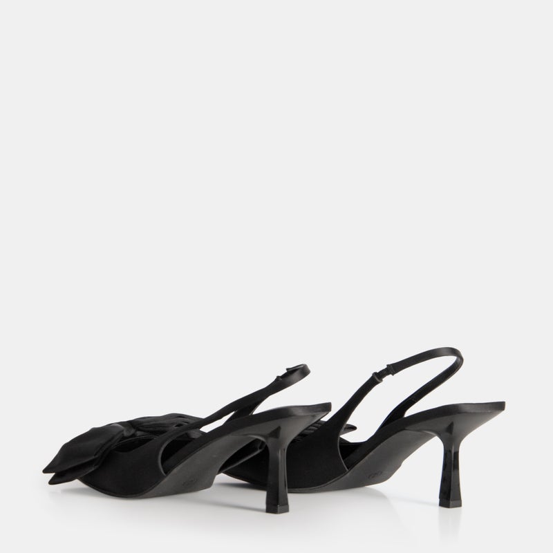 Black strappy high heel sandals with slender ankle strap and open toe design, displaying elegant black heels suitable for dressy and formal occasions.